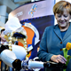 Image for article titled Why Is Angela Merkel Always Palling Around With Robots?